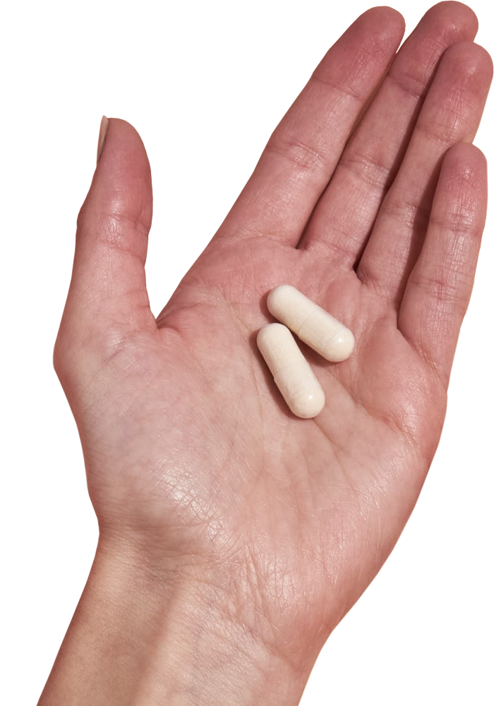 image of hand holding 2 Performance Lab® RoW Magnesium capsules