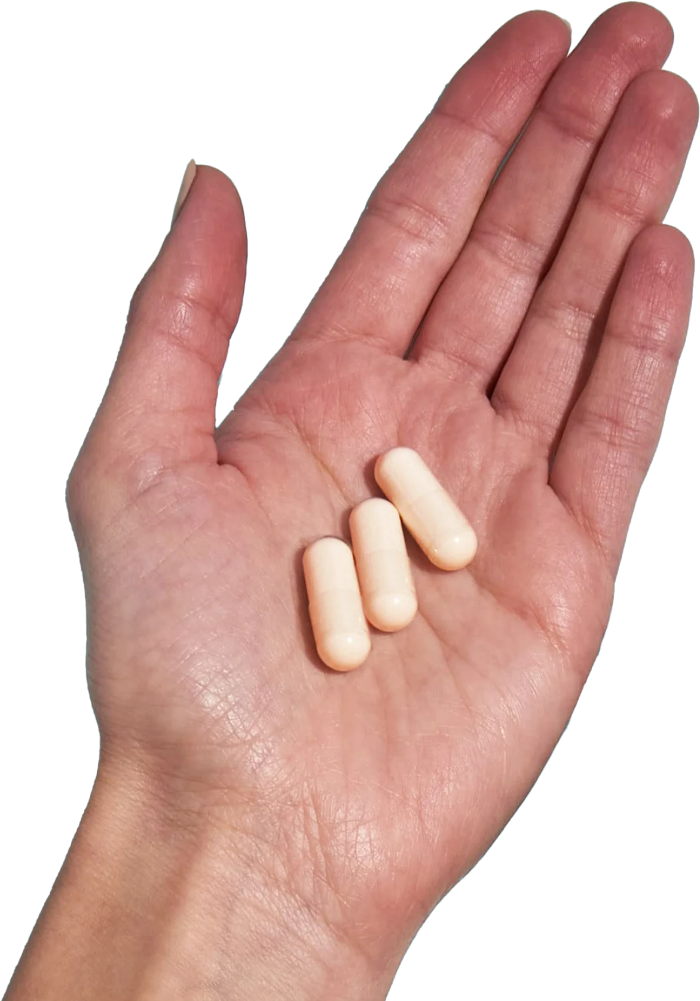 image of hand holding 3 Performance Lab® RoW Magnesium capsules
