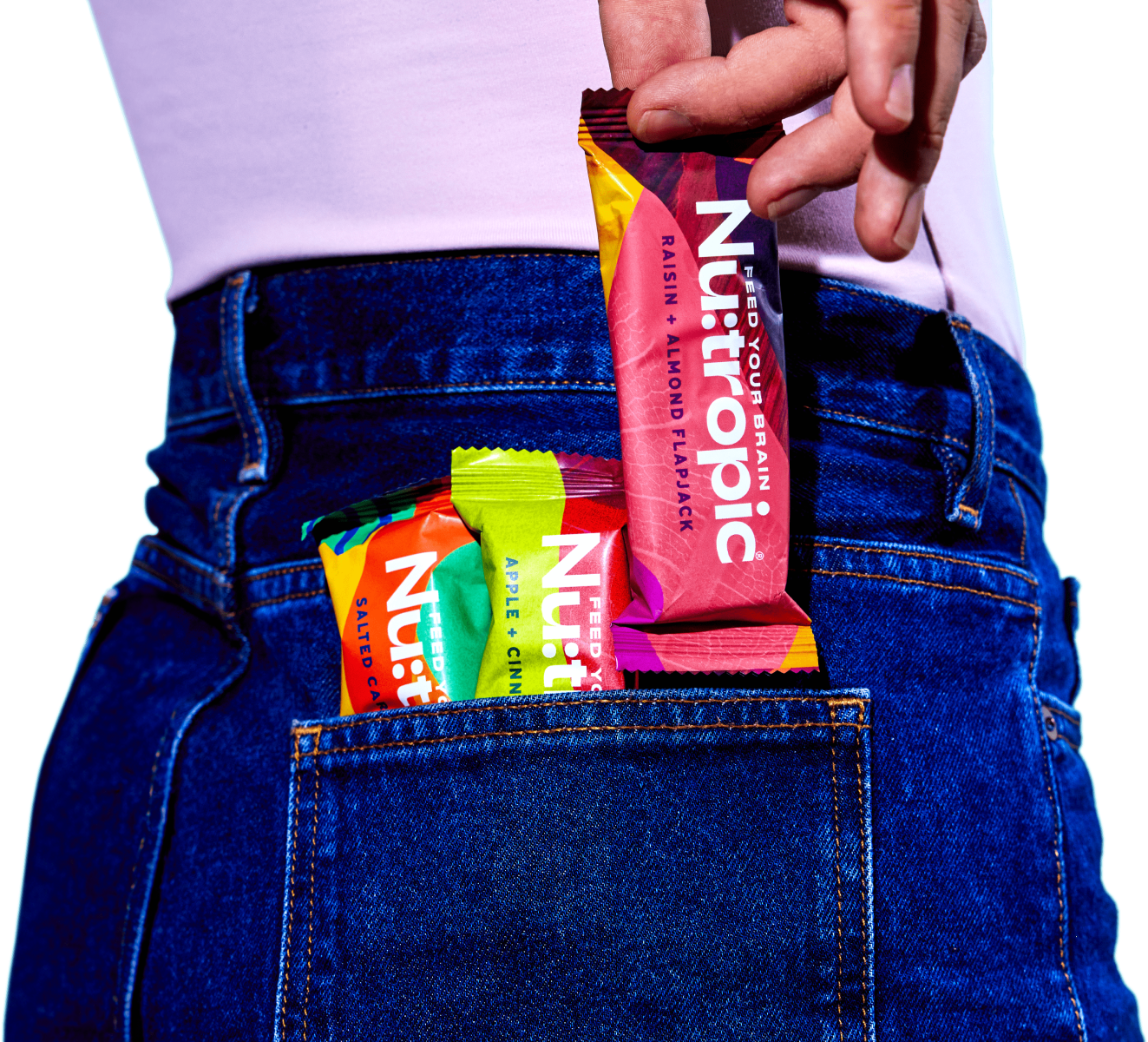 image of someone putting a Nu:tropic® bar in the back pocket of their jeans