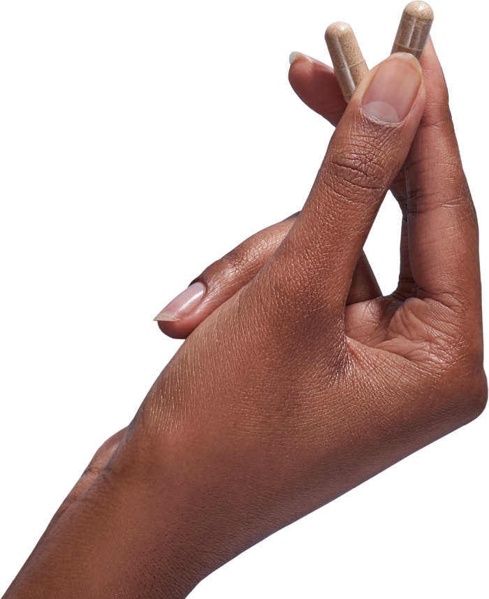 image of hand holding 2 Performance Lab® RoW Vitamin C capsules